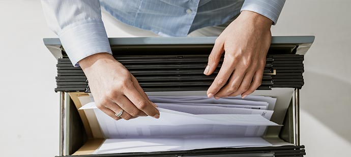 Person at a filling cabinet | LGI General terms